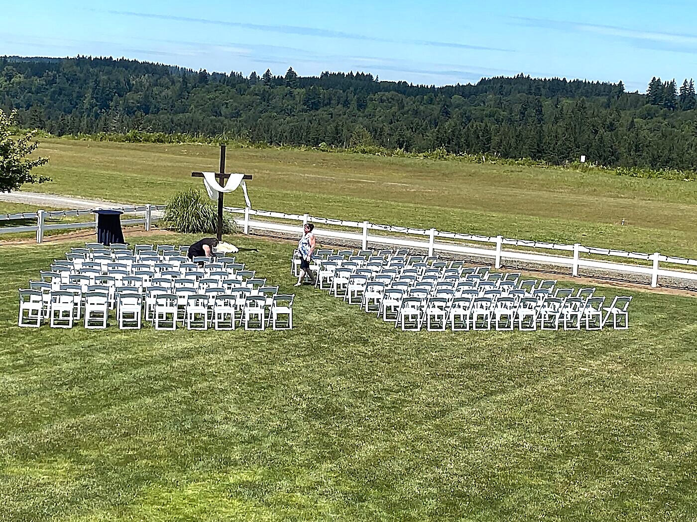 Wedding party and family setting up chairs and decorations during rehearsal the day before the ceremony at Sandy River Airport